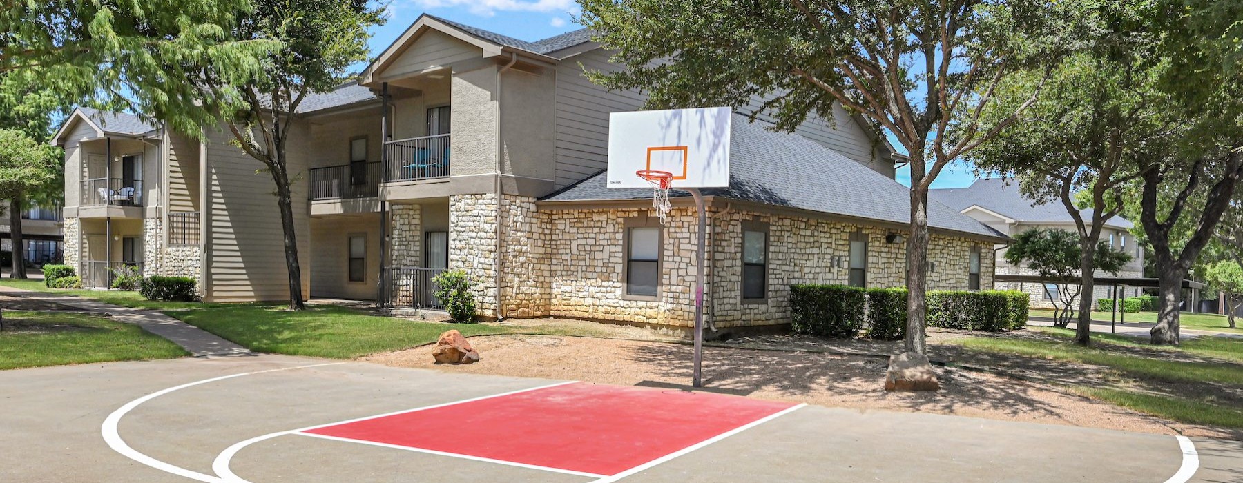 a basketball court in front of a building