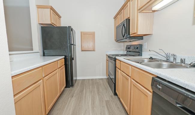 a kitchen with wooden cabinets