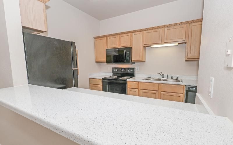 a kitchen with wooden cabinets