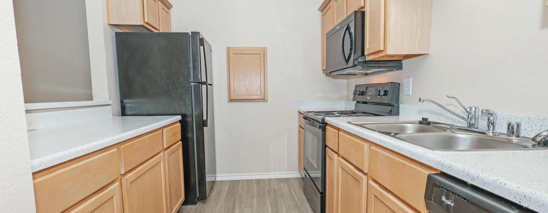 a kitchen with wooden cabinets